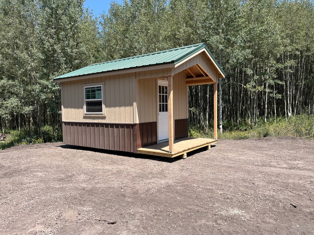 Rustic cabin among the trees at Uncompahgre Adventures