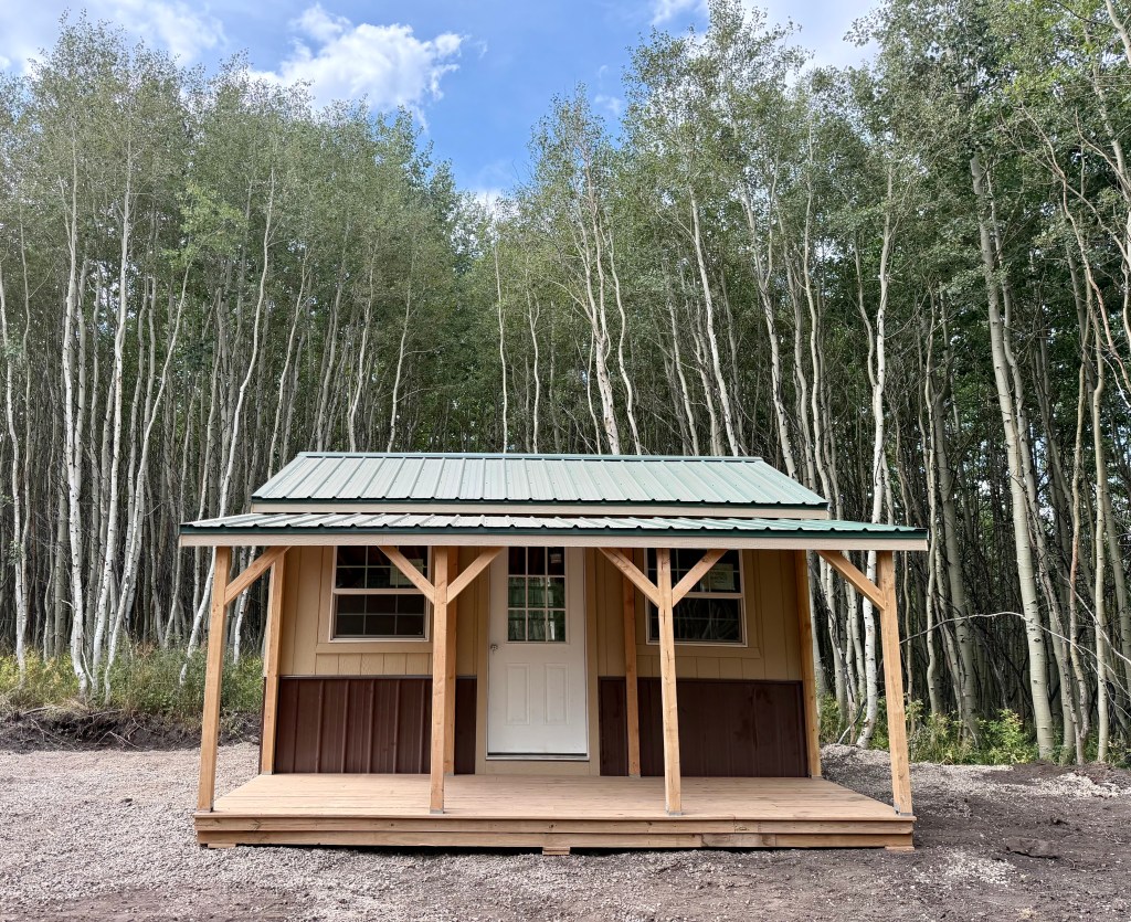 Rustic cabin with porch at Uncompahgre Adventures in Colorado
